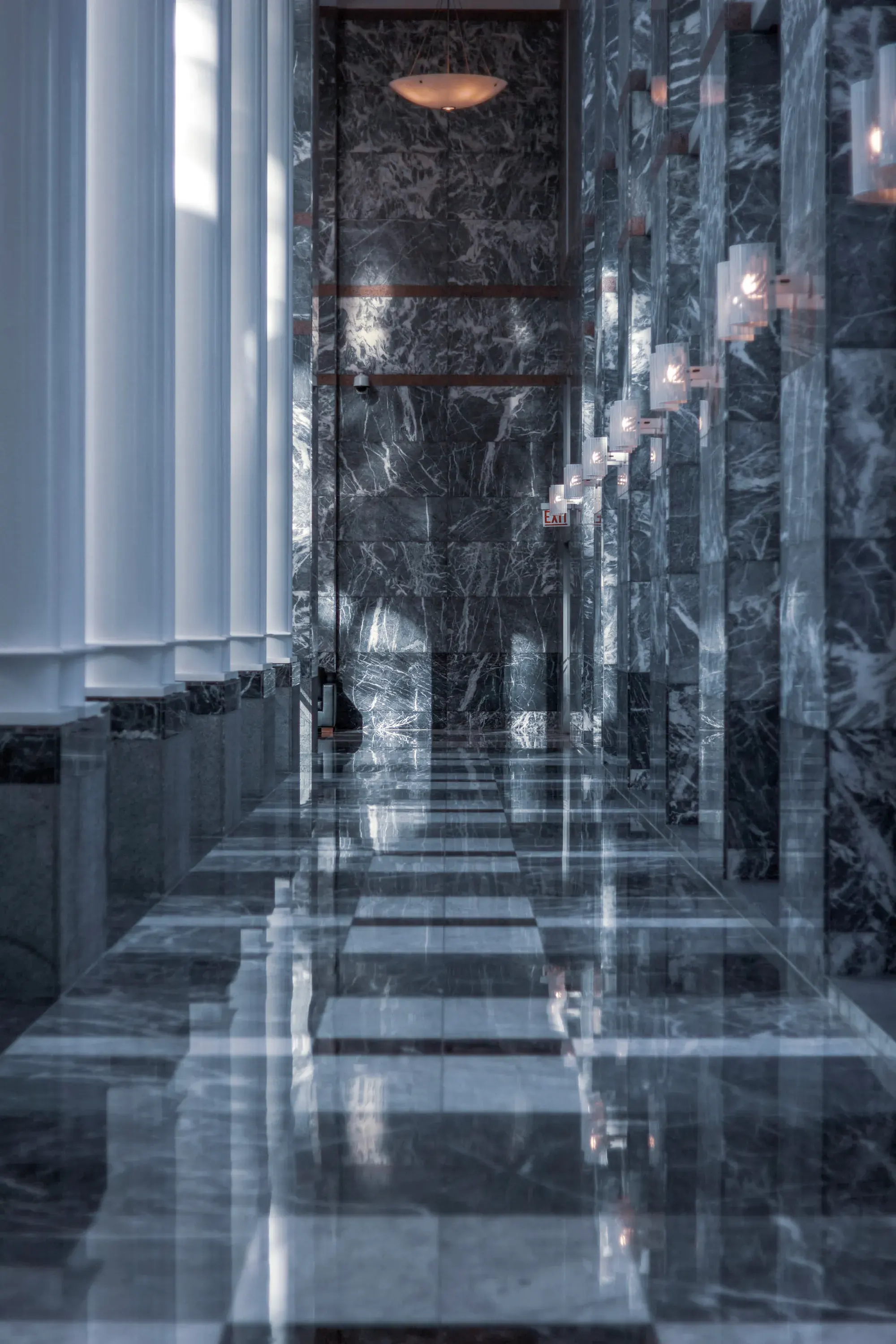 A marble colonnade receding into the light